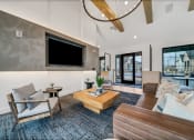 Thumbnail 31 of 45 - a living room with couches and a tv at The BLVD at Wilson Crossings, Wyoming Michigan
