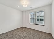 Thumbnail 62 of 68 - A room with a window and a carpeted floor. at The Sophia, Venice, FL
