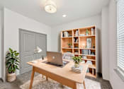 Thumbnail 63 of 68 - A room with a laptop on a desk and a bookshelf with various items. at The Sophia, Venice, FL