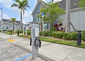 Thumbnail 56 of 68 - A charging station for electric vehicles is located on a sidewalk in front of a building. at The Sophia, Venice, FL