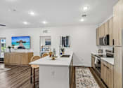 Thumbnail 3 of 124 - Kitchen island with white countertop and bar seating at Velara Luxury Apartments, Ponte Vedra Beach, FL