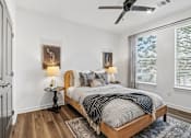Thumbnail 48 of 124 - Bedroom with wood bed frame and ceiling fan at Velara Luxury Apartments, Ponte Vedra Beach, Florida