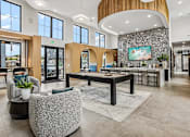 Thumbnail 2 of 24 - A spacious lobby with a reception desk and a large painting on the wall.