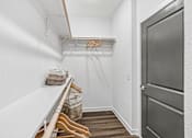 Thumbnail 52 of 124 - Walk-in closet with hanging rods and shelf at Velara Luxury Apartments, Ponte Vedra Beach, FL