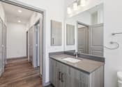 Thumbnail 41 of 62 - A bathroom with a sink, mirror, and toilet.