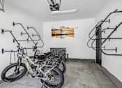 Thumbnail 19 of 24 - A motorcycle is parked in a garage with a picture of a building on the wall.