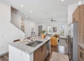 Thumbnail 40 of 43 - A modern kitchen with a granite countertop and stainless steel appliances. at The Hadley - North Port, FL Apartments, North Port