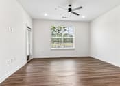 Thumbnail 54 of 124 - Spacious empty room with window and hardwood floors at Velara Luxury Apartments, Ponte Vedra Beach, Florida