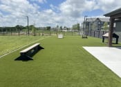 Thumbnail 59 of 88 - a park with a bench in the middle of a field at The Depot Raymore, MO 64083
