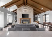 Thumbnail 10 of 46 - a large living room with a large couch and a fireplace at Alta25, Monument, Colorado, 80132