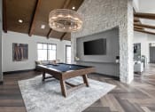 Thumbnail 24 of 46 - a large living room with a pool table and a tv at Alta25, Monument, CO, 80132
