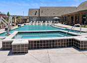 Thumbnail 46 of 46 - A large outdoor swimming pool with a slide and sun loungers.