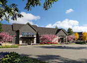 Thumbnail 2 of 4 - A large building with a grey roof and a driveway in front.
