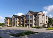 Thumbnail 3 of 4 - A large, modern building with a parking lot in front.
