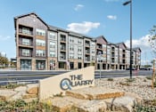 Thumbnail 1 of 59 - the quarter at the quarter apartments sign in front of an apartment building at The Quarry Luxury Apartment Homes, Fort Collins, Colorado