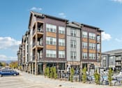 Thumbnail 56 of 59 - an apartment building with a fence and a parking lot at The Quarry Luxury Apartment Homes, Colorado
