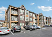 Thumbnail 53 of 59 - a parking lot with cars in front of an apartment building at The Quarry Luxury Apartment Homes, Colorado