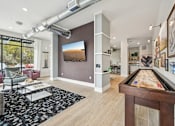 Thumbnail 31 of 59 - a game room with a pool table and a tv at The Quarry Luxury Apartment Homes, Fort Collins