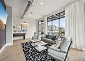 Thumbnail 32 of 59 - a living room with a couch and a coffee table at The Quarry Luxury Apartment Homes, Fort Collins, CO