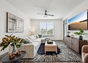 Thumbnail 3 of 59 - a living room with a white couch and a large window at The Quarry Luxury Apartment Homes, Fort Collins, CO