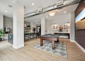 Thumbnail 29 of 59 - a community room with a pool table and a bar at The Quarry Luxury Apartment Homes, Colorado, 80526