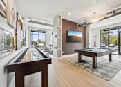 Thumbnail 30 of 59 - a billiards room with a pool table and a large window at The Quarry Luxury Apartment Homes, Colorado, 80526