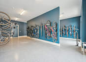 Thumbnail 51 of 59 - a room with bikes hanging on a blue wall at The Quarry Luxury Apartment Homes, Fort Collins
