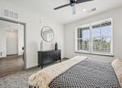 Thumbnail 13 of 59 - a bedroom with a bed and a ceiling fan at The Quarry Luxury Apartment Homes, Fort Collins, CO, 80526