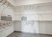 Thumbnail 15 of 59 - a walk in closet with hangers and a dryer at The Quarry Luxury Apartment Homes, Fort Collins, Colorado