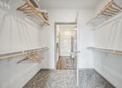 Thumbnail 19 of 59 - a walk in closet with wooden racks and a mirror at The Quarry Luxury Apartment Homes, Colorado