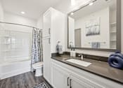 Thumbnail 20 of 59 - a bathroom with a large mirror and a toilet and a shower at The Quarry Luxury Apartment Homes, Fort Collins