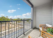 Thumbnail 22 of 59 - a balcony with a view of a blue sky and trees at The Quarry Luxury Apartment Homes, Fort Collins