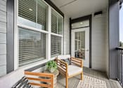 Thumbnail 21 of 59 - a front porch with two benches and a potted plant at The Quarry Luxury Apartment Homes, Colorado, 80526