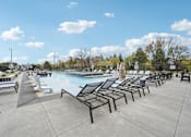 Thumbnail 41 of 59 - the pool with pool chairs at The Quarry Luxury Apartment Homes, Fort Collins, CO