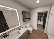 Thumbnail 16 of 32 - A bathroom with a white sink and a mirror.