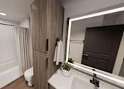 Thumbnail 12 of 32 - A bathroom with a white tub, sink, and toilet.