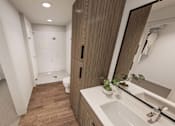 Thumbnail 20 of 32 - A bathroom with a white sink and a mirror.