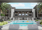 Thumbnail 13 of 21 - A modern building with a pool in front at Refinery at Pointe17 Apartments, Phoenix, AZ