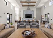 Thumbnail 20 of 27 - A modern living room with a wooden table in the center and grey chairs at Stella, San Tan Valley Arizona