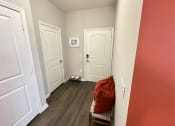Thumbnail 47 of 56 - a living room with red walls and white doors at Watermark at Steele Crossing, Fayetteville, AR, 72703