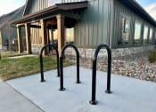 Thumbnail 54 of 88 - a row of bike racks in front of a building at The Depot, Raymore, MO, 64083