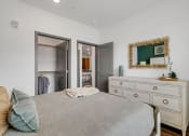 Thumbnail 15 of 31 - a bedroom with a bed and a dresser  at Prism at Diamond Ridge, Moon Township, PA
