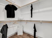 Thumbnail 17 of 31 - a walk in closet with white walls and a wooden rod with clothes hanging on it  at Prism at Diamond Ridge, Moon Township, PA, 15108