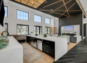 Thumbnail 28 of 31 - a kitchen with an island and a living room in the background  at Prism at Diamond Ridge, Pennsylvania, 15108