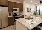 Thumbnail 5 of 18 - A modern kitchen with a granite countertop and stainless steel appliances at The Stadler Luxury Apartments, Bradenton, Florida