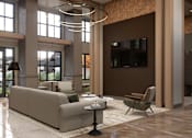 Thumbnail 16 of 24 - A modern living room with a large couch, a chair, and a coffee table.