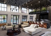 Thumbnail 3 of 16 - A modern living room with a large white sofa and a coffee table at The Logan Luxury Apartments, Nampa