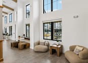 Thumbnail 19 of 20 - A white room with a large window and a couch.