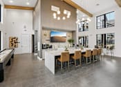 Thumbnail 1 of 20 - A modern kitchen with a pool table and a dining table.