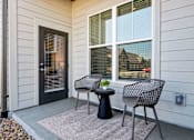 Thumbnail 15 of 20 - A patio with a table and two chairs.
